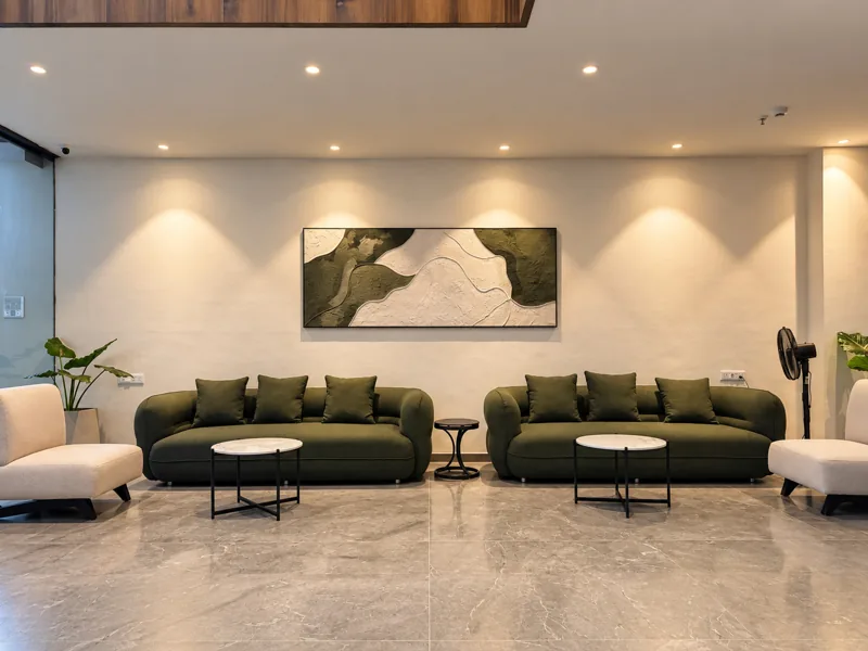 Lobby lounge with green sofas at Amara Hotel, Nizamabad